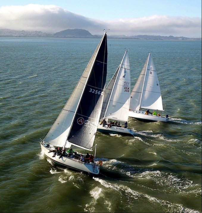 Photo of the two boats with handicaps in the 70s and Papoose heading to the first mark all three side by side.