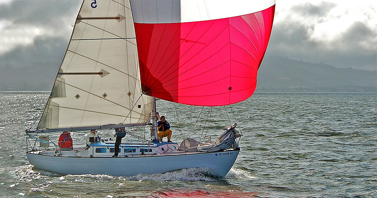 Lapworth 36 Papoose flying a red spinnaker on San Francisco Bay.
